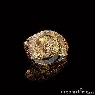 Gold nugget on black background. Stock Photo