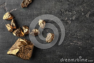 Gold nuggets on dark background Stock Photo