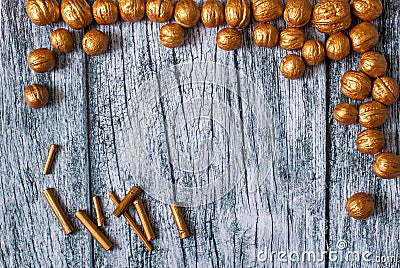 Gold nuts and gilt sticks on the background of old wooden panels, Christmas background Stock Photo