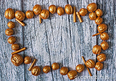 Gold nuts and gilt sticks on the background of old wooden panels, Christmas background Stock Photo