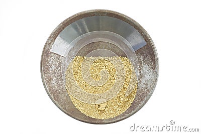 A gold pan filled with natural placer gold Stock Photo