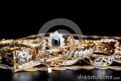 Gold in pile ring chain necklace on black background Stock Photo