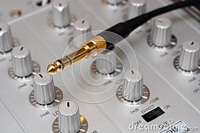 Gold plug on dj music mixer Stock Photo