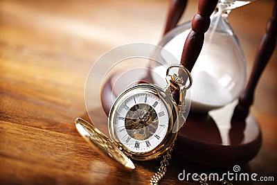 Gold pocket watch and hourglass Stock Photo