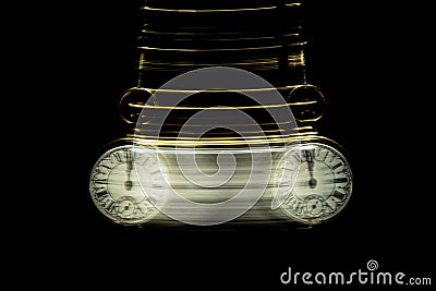 Gold Pocket watch swinging hypnotically from chain. Black background Stock Photo