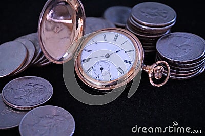 Gold pocketwatch double hunter case with coins Stock Photo