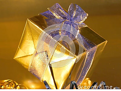 Gold present with blue ribbons Stock Photo