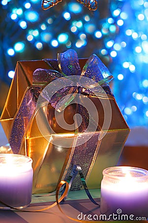 Gold present lit by candles Stock Photo