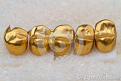 Gold prosthetic teeth on sugar Stock Photo