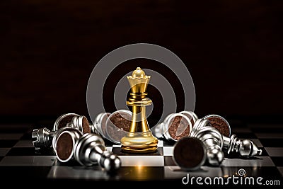 Gold queen chess surrounded by a number of fallen silver chess p Stock Photo