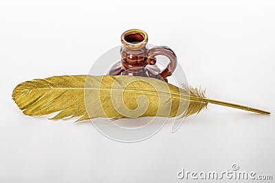 Gold quill pen and antique inkstand on white background Stock Photo