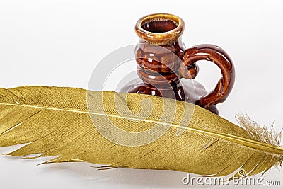Gold quill pen and antique inkstand on white background Stock Photo