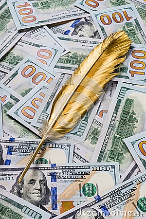 Gold quill pen on dollar money background Stock Photo