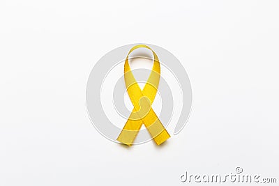 Gold ribbon as symbol of childhood cancer awareness isolated on Stock Photo