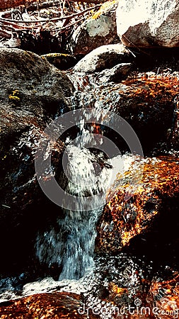 Gold rocks in a waterfall Stock Photo