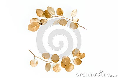 Gold round frame made of gold branches eucalyptus and leaves isolated on white background. lay flat, top view Stock Photo