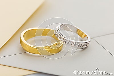 Gold and silver wedding rings on envelope background Stock Photo
