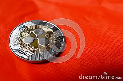 Ripple XRP coin on orange background Editorial Stock Photo