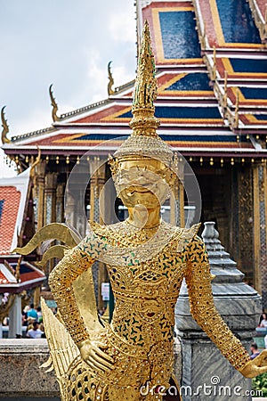 Gold statue of Kinnari, mythical creature half human half bird, at Temple of Emerald Buddha Editorial Stock Photo