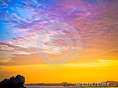 Gold sun light and stone seaside in Thailand Stock Photo