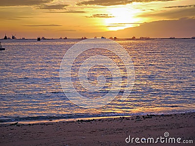 Gold sun light and stone seaside in Thailand Stock Photo