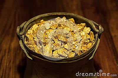 Gold treasure in a copper kettle Stock Photo