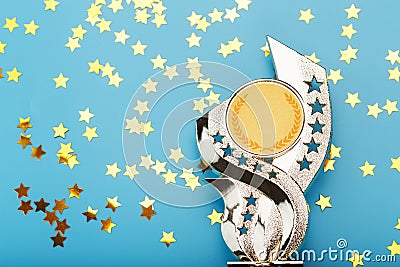 Gold trophy Cup with stars Celebrating success on a blue background Stock Photo