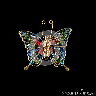 Gold vintage brooch covered with colored enamel in the shape of a butterfly Stock Photo