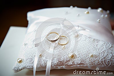 Gold wedding ring on pillow with pearl Stock Photo