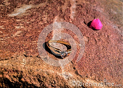 Gold Wedding Ring on a Rock Surface Stock Photo