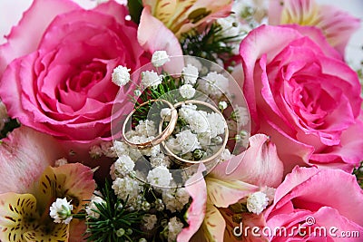 Gold wedding rings on a flower background Stock Photo