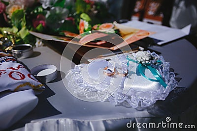 Gold wedding rings on a pillow in the shape of a heart Stock Photo