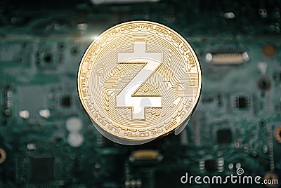 Gold zcash coin, on background of computer motherboard Stock Photo