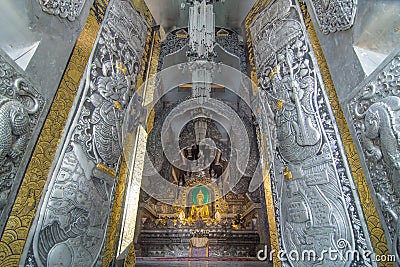 Golden ancient buddha in The silver ubosot (ordination hall) of Editorial Stock Photo