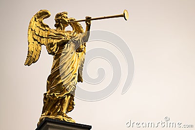 Golden angel with a trumpet and copy space. Stock Photo