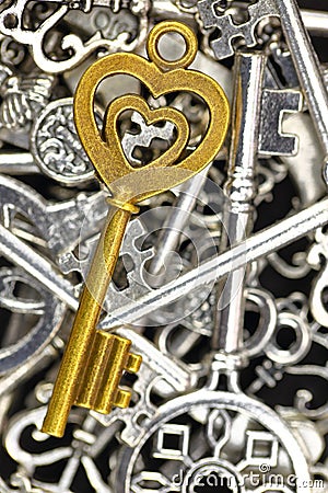 Golden antique key on pile of metallic keys Stock Photo