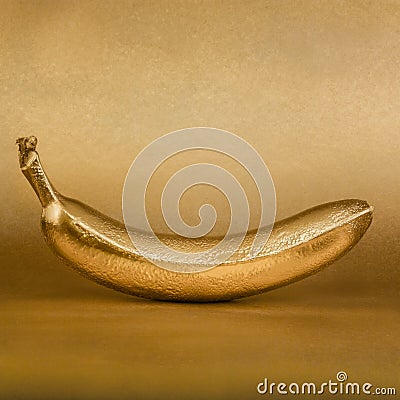 Golden banana on gold background Stock Photo