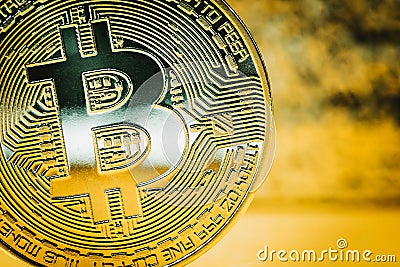 Golden bitcoin on a blurred background. Close up Stock Photo