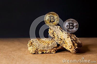 Gold and silver Bitcoin Coins balances on natural stones on dark background. Blockchain cryptocurrency, store of value Stock Photo