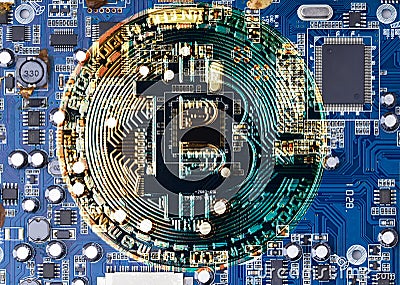 Golden Bitcoin Cryptocurrency on computer circuit board CPU. Mining of crypto-currency concept. Bitcoin logo on circuit board Stock Photo