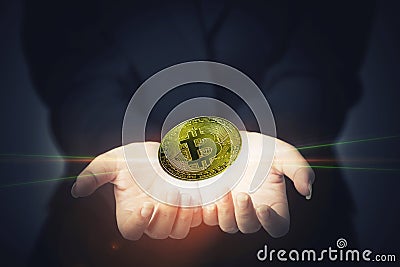 Golden bitcoin on hand. Digital money concept. Online business a Stock Photo