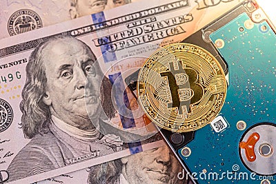 Golden bitcoin, hard disk, and us dollars Stock Photo