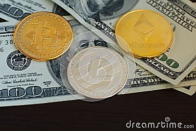 Golden bitcoin, silver litecoins and ethereum on us dollars close up Editorial Stock Photo