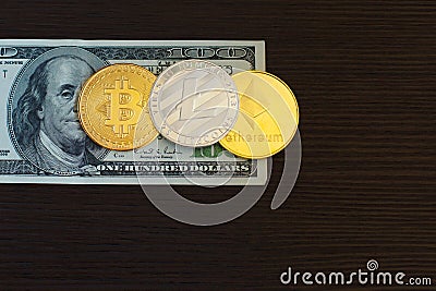 Golden bitcoin, silver litecoins and ethereum on us dollars close up Editorial Stock Photo