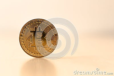 Golden Bitcoin on table with a reflective surface of bitcoin , cGolden Bitcoin on table with a reflective surface of bitcoin Stock Photo