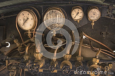 Golden and black Pressure gauge and Feed water pump valves of an Stock Photo