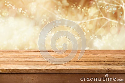 Golden bokeh background with empty wooden table for product montage display Stock Photo