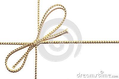 Golden bow with gift ribbon wrap for Christmas present with intricate shine details isolated cut out simple plain white background Stock Photo