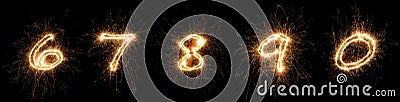 Golden bright sparkler number digits font set collection part 6 to 0 isolated dark black background. silvester new year birthday Stock Photo