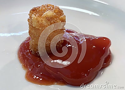 Tater tot and ketchup on a white plate Stock Photo